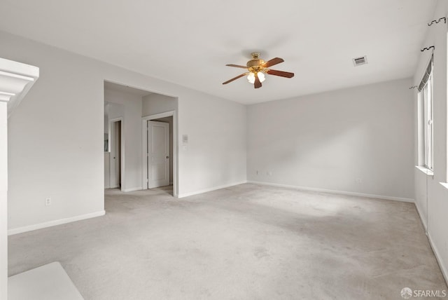 empty room featuring ceiling fan and light carpet