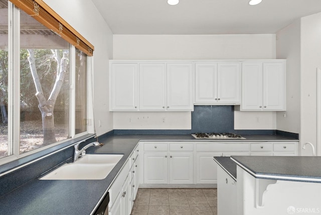 kitchen with white cabinets, sink, stainless steel appliances, and light tile patterned flooring