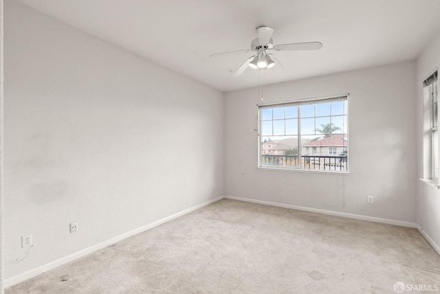 empty room with ceiling fan and light colored carpet