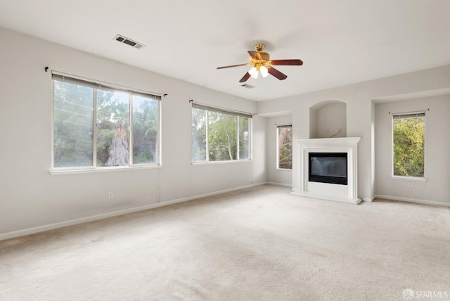 unfurnished living room with light carpet and ceiling fan