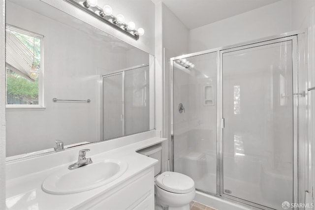 bathroom with vanity, an enclosed shower, and toilet