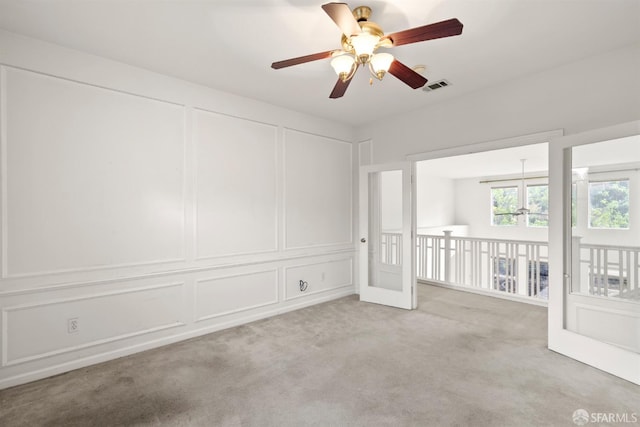 unfurnished room with ceiling fan and light colored carpet