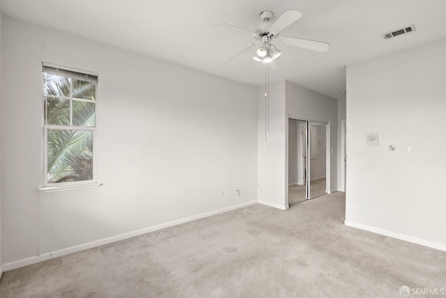 carpeted empty room featuring ceiling fan