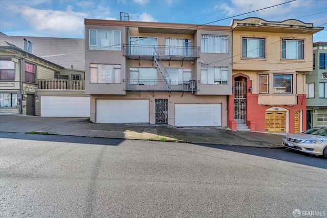 view of property featuring a balcony and a garage