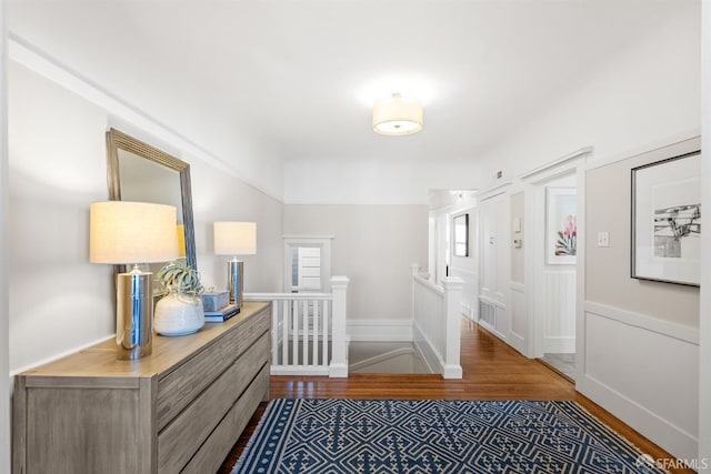 corridor with hardwood / wood-style floors