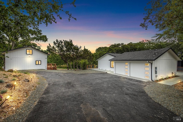 view of garage at dusk