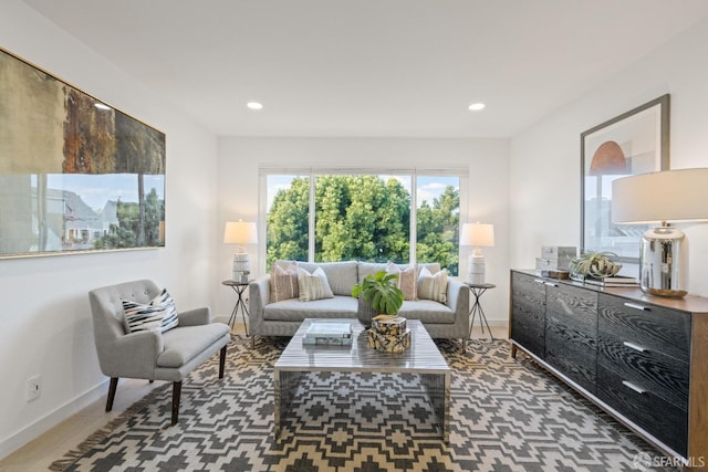 living area with baseboards and recessed lighting