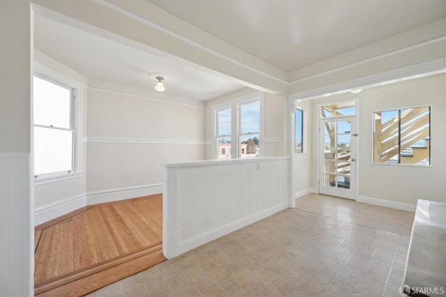 spare room with baseboards and light floors