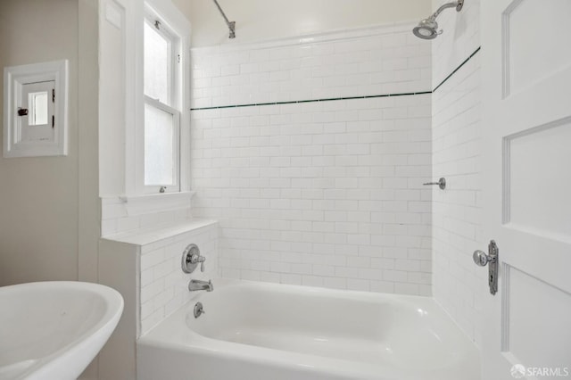 bathroom featuring a sink and shower / bath combination