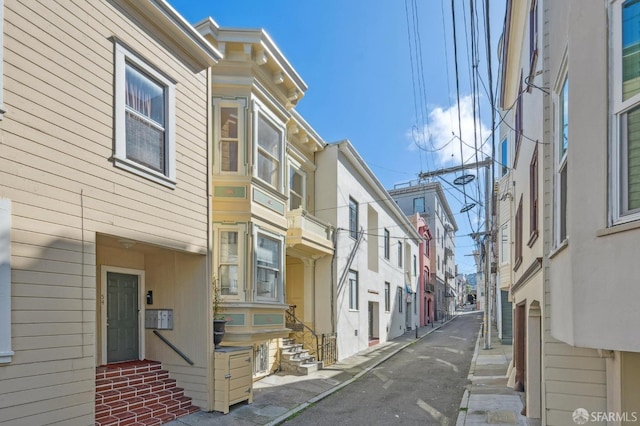 view of street featuring a residential view and entry steps