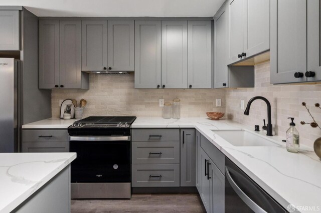 363 Prague St, San Francisco, CA 94112 - kitchen with gray cabinets, stainless steel appliances, decorative backsplash, and light stone countertops