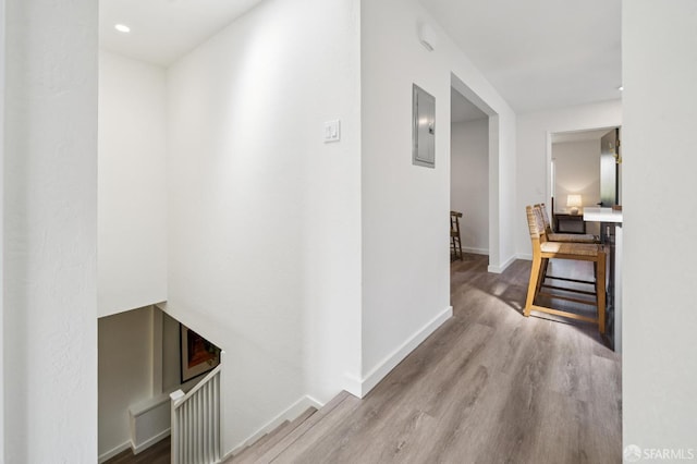 363 Prague St, San Francisco, CA 94112 - hallway with an upstairs landing, electric panel, wood finished floors, and recessed lighting
