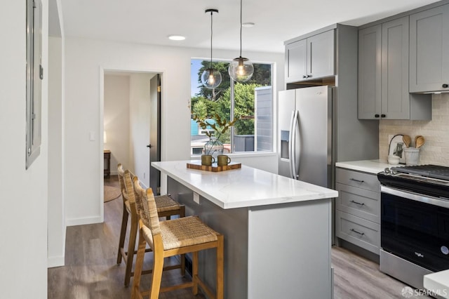 363 Prague St, San Francisco, CA 94112 - kitchen featuring gray cabinets, stainless steel appliances, decorative backsplash, a center island, and recessed lighting