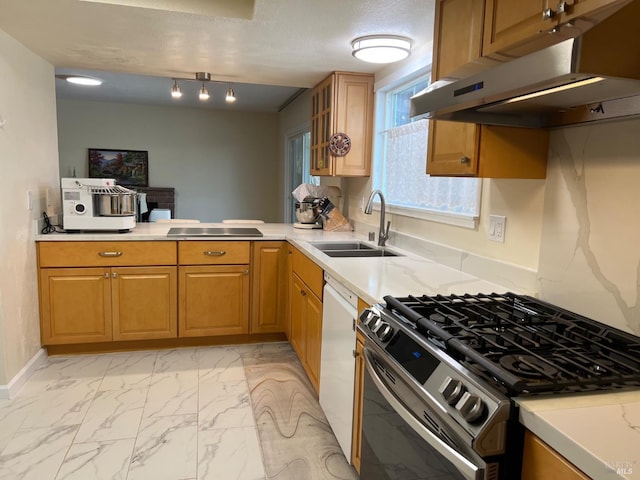 kitchen with marble finish floor, light countertops, gas stove, a sink, and under cabinet range hood