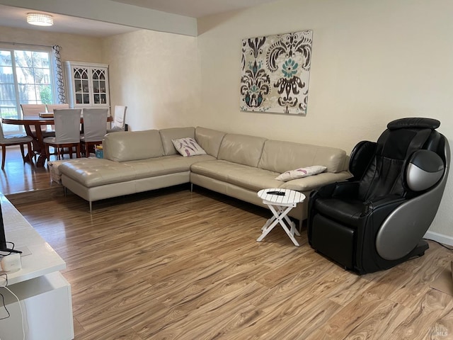 living area with light wood finished floors and baseboards