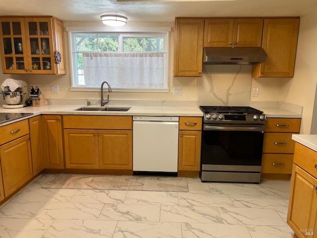 kitchen featuring white dishwasher, under cabinet range hood, a sink, marble finish floor, and stainless steel gas range