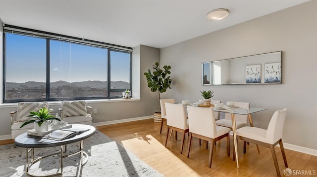 dining area featuring wood finished floors and baseboards