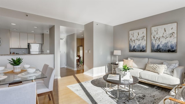 living room featuring light wood finished floors and baseboards