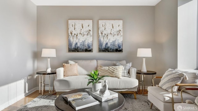 living room featuring baseboards and wood finished floors