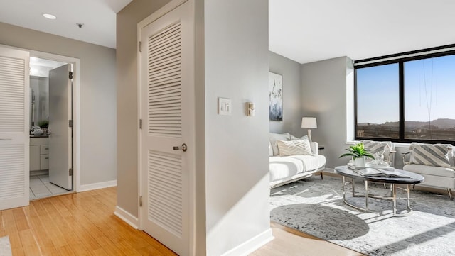 living area featuring light wood-style flooring and baseboards