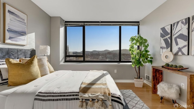 bedroom with wood finished floors and baseboards