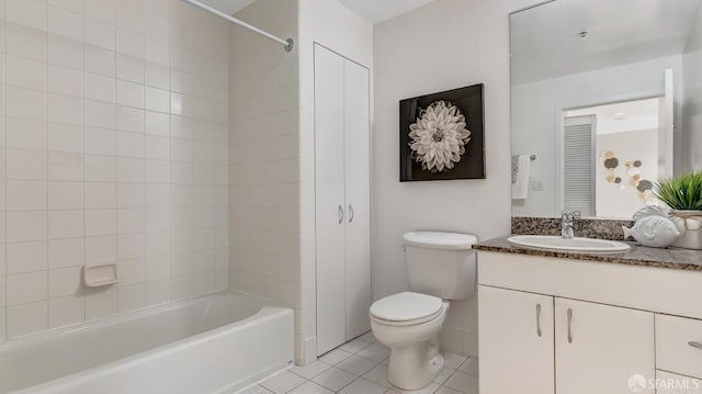 bathroom with tile patterned flooring, bathtub / shower combination, vanity, and toilet