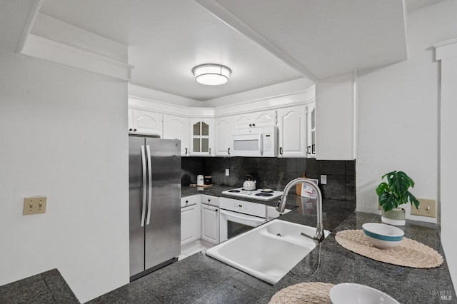 kitchen with white cabinetry, white appliances, sink, and tasteful backsplash