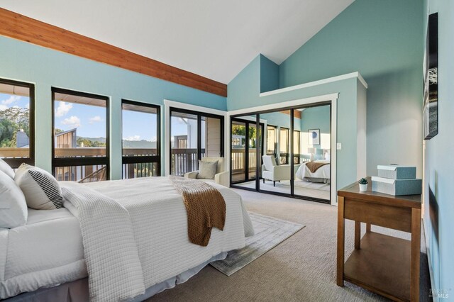 carpeted bedroom featuring access to outside, a closet, and high vaulted ceiling