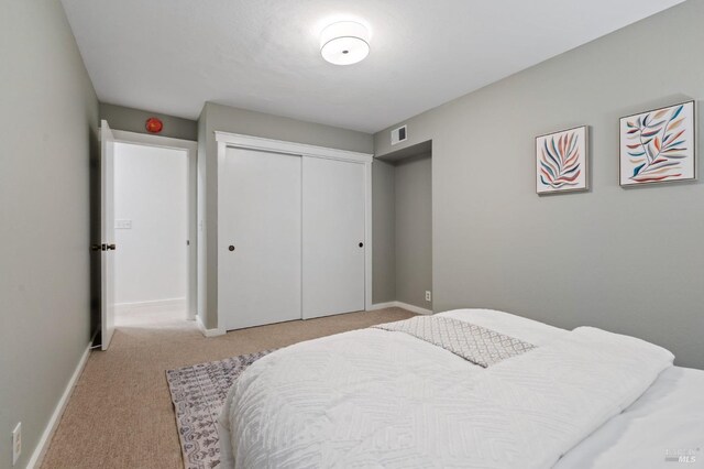 carpeted bedroom with a closet