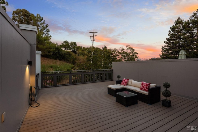 deck at dusk with an outdoor living space