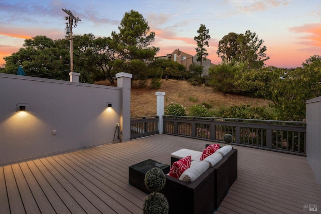 deck at dusk with an outdoor living space