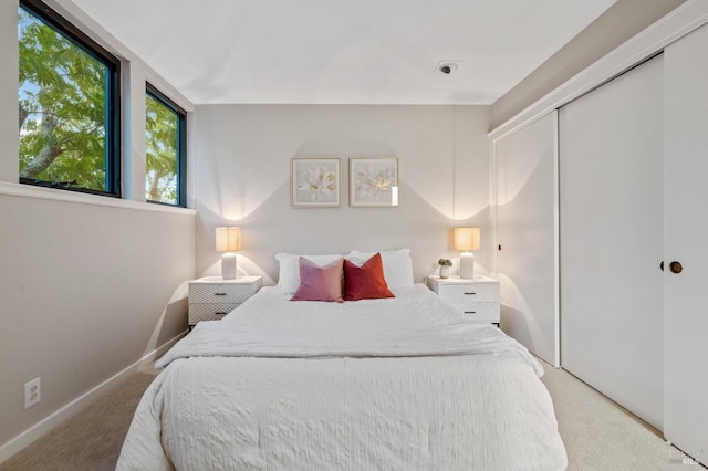 bedroom with a closet and light colored carpet