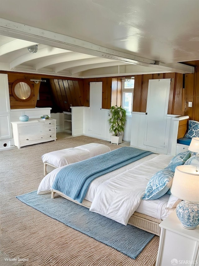 bedroom featuring beamed ceiling, wooden walls, and carpet floors