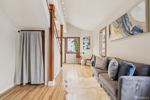 1285 Holloway Ave, San Francisco, CA 94132 - living room featuring vaulted ceiling, light wood-style floors, and stairs