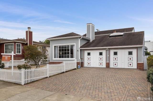 1285 Holloway Ave, San Francisco, CA 94132 - back of property with decorative driveway, board and batten siding, a chimney, an attached garage, and brick siding