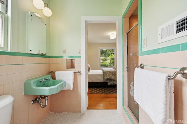 1285 Holloway Ave, San Francisco, CA 94132 - ensuite bathroom with tile walls, a shower stall, and wainscoting