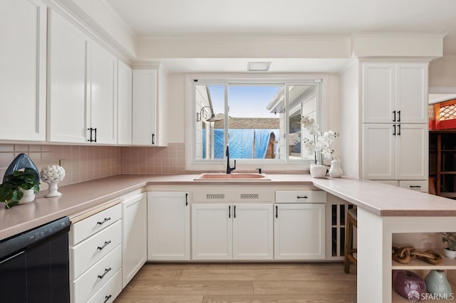 1285 Holloway Ave, San Francisco, CA 94132 - kitchen with black dishwasher, white cabinetry, light countertops, and decorative backsplash