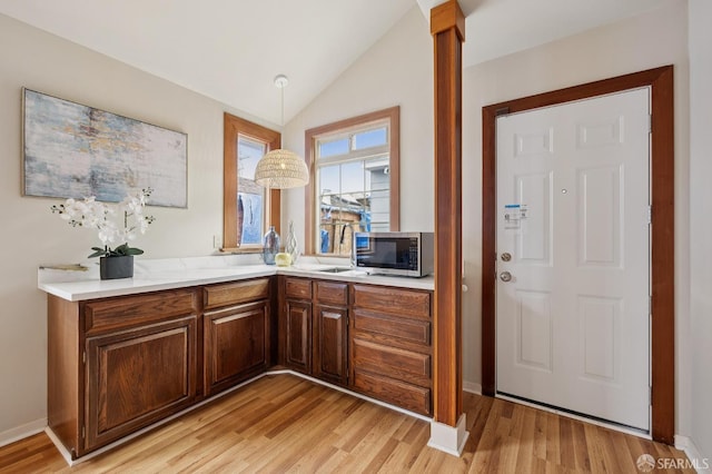 1285 Holloway Ave, San Francisco, CA 94132 - bar area featuring stainless steel microwave, light wood finished floors, vaulted ceiling, and ornate columns