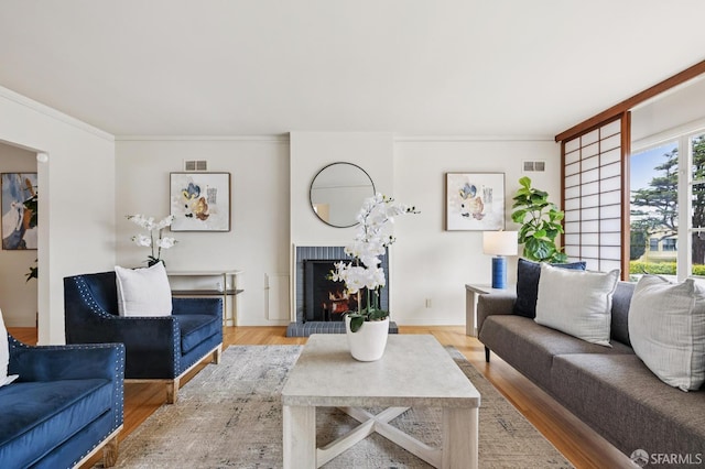 1285 Holloway Ave, San Francisco, CA 94132 - living area featuring light wood finished floors, a brick fireplace, and crown molding