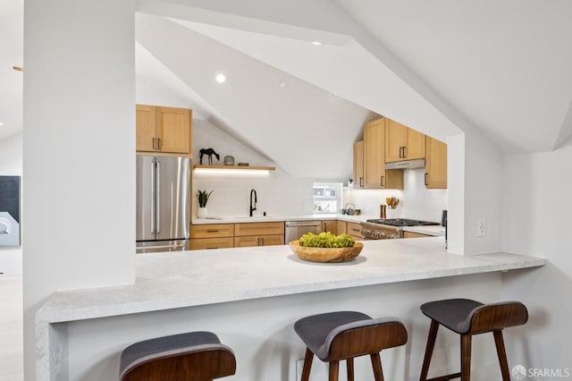 102 Baker St Unit A, San Francisco, CA 94117 - kitchen with appliances with stainless steel finishes, a peninsula, decorative backsplash, vaulted ceiling, and recessed lighting