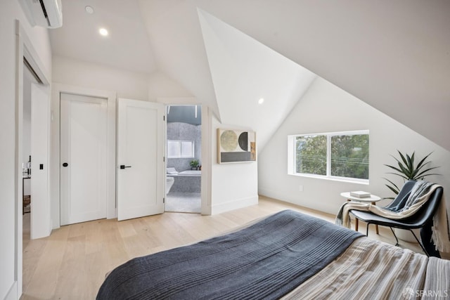102 Baker St Unit A, San Francisco, CA 94117 - bedroom featuring light wood-style flooring, vaulted ceiling, a wall unit AC, recessed lighting, and ensuite bath