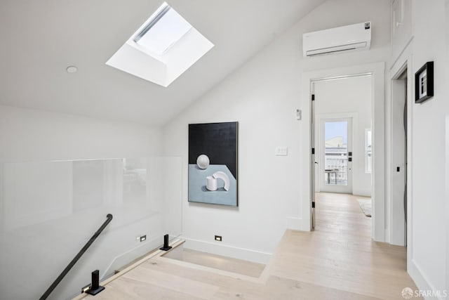 102 Baker St Unit A, San Francisco, CA 94117 - hallway featuring an AC wall unit, a skylight, lofted ceiling, and light wood-type flooring