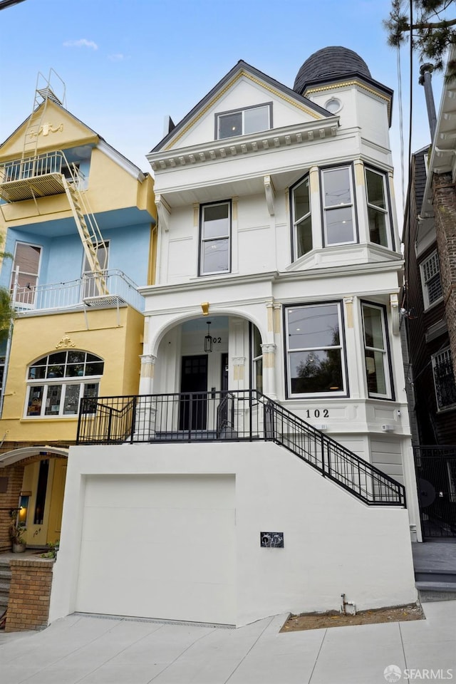 102 Baker St Unit A, San Francisco, CA 94117 - view of front of property featuring a garage, stucco siding, and concrete driveway
