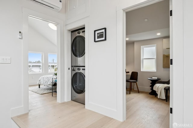 102 Baker St Unit A, San Francisco, CA 94117 - laundry room featuring stacked washer / dryer, light wood-type flooring, an AC wall unit, and recessed lighting