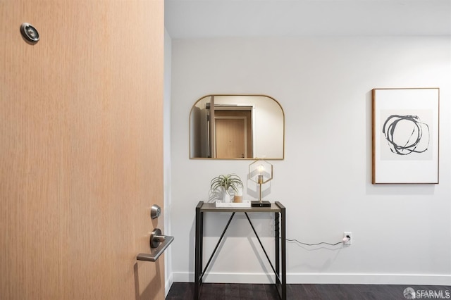 interior details with baseboards and wood finished floors