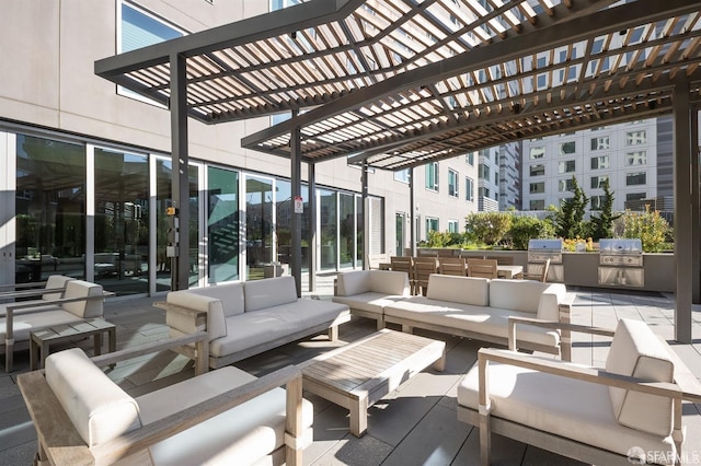 view of patio featuring an outdoor kitchen, grilling area, outdoor lounge area, and a pergola