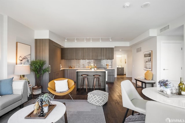 living room featuring dark wood-style floors and visible vents