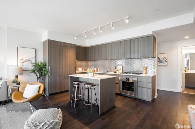 kitchen featuring a breakfast bar, modern cabinets, and oven