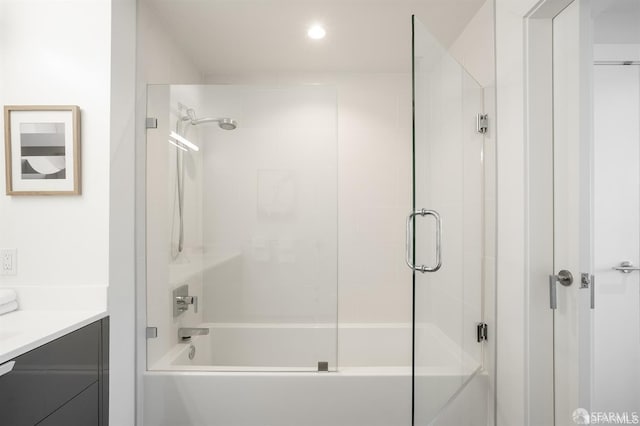 full bathroom with enclosed tub / shower combo and vanity