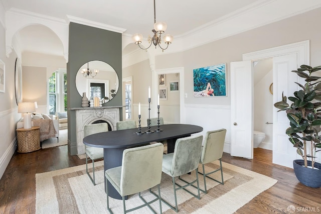 1908 Buchanan St, San Francisco, CA 94115 - dining room with a chandelier, wood finished floors, crown molding, and arched walkways